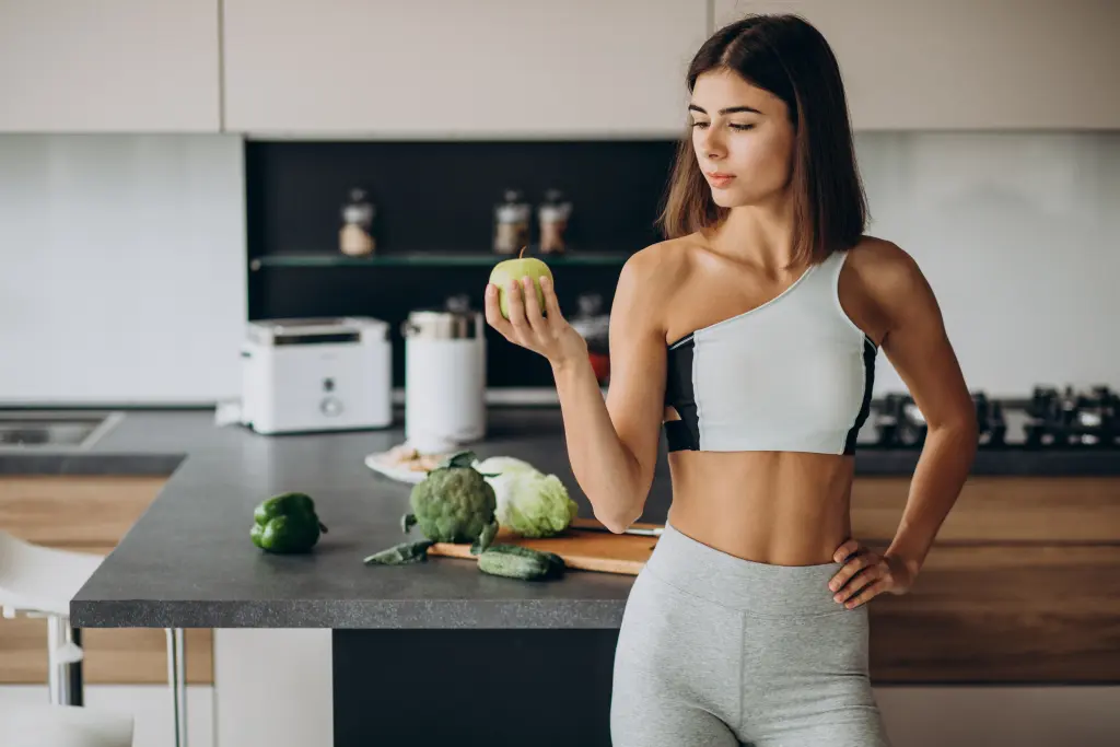 sporty-woman-with-apple-at-the-kitchen.jpg